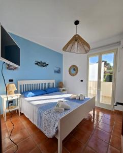 a bedroom with a bed and a desk and a tv at Villa Aloe di Calanica Cefalù in Cefalù +55 photos
