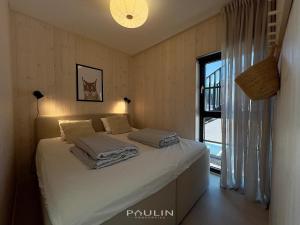 a bedroom with a bed with white sheets and a window at Lindvallen Ski Resort Pool and Padel - Sauna - 6 Guests in Sälen +22 photos