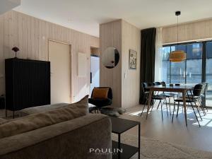a living room with a couch and a table at Lindvallen Ski Resort Pool and Padel - Sauna - 6 Guests in Sälen