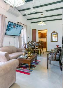 a living room with a couch and a table at New! Mangalam house, Private plunge pool near beach in Trincomalee