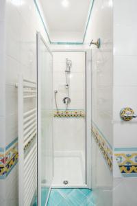 a shower with a glass door in a bathroom at Villa nella curva della funicolare, Capri in Capri +31 photos
