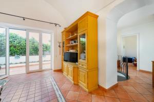 a kitchen with a yellow cabinet with a microwave at Villa nella curva della funicolare, Capri in Capri