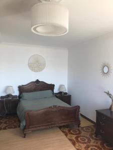 a bedroom with a bed with two night stands and two lamps at Aires da Ría Apartamento con vista al mar in Marín