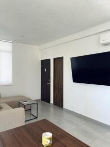 a living room with a flat screen tv on a wall at Casa Ivanna Vallarta in Puerto Vallarta