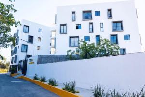 a white building with a fence in front of it at Casa Ivanna Vallarta in Puerto Vallarta