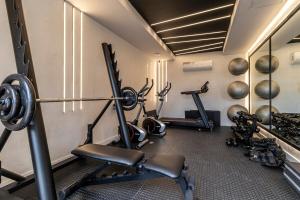 a fitness room with two treadmills and two machines at Apartamento Carioca in Rio de Janeiro