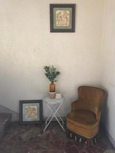 a room with a chair and a table with a plant at Aires da Ría Apartamento con vista al mar in Marín +29 photos