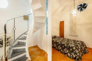 a staircase in a room with a bed at Villa nella curva della funicolare, Capri in Capri
