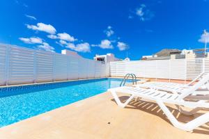 a swimming pool with a lounge chair and a swimming pool at Nice apartment with wifi and pool in Port de Pollensa