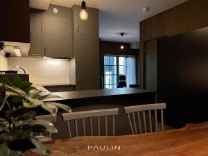 a kitchen with a table and chairs and a counter at Lindvallen Ski Resort Pool and Padel - Sauna - 6 Guests in Sälen