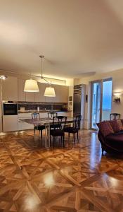 a kitchen and dining room with a table and chairs at Il Grattacielo Luxury Home - Pinerolo Center - Confort and Beautiful View in Pinerolo