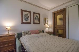 une chambre avec un lit et deux tableaux au mur dans l'établissement Cà Mughi Studio, à Zuel