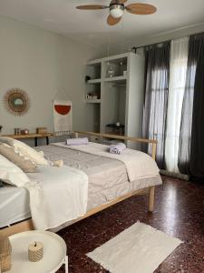 a bedroom with two beds and a ceiling fan at Levanda Home in Taktikoúpolis