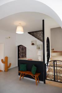 a living room with a bench and a staircase at Tenuta Maison Angelina in Formia