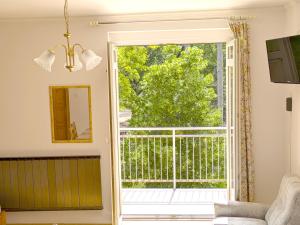 a living room with a sliding glass door at Lívia Apartman in Balatonfüred