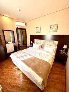 a bedroom with a large bed with white sheets at Dreamland oasis in Chakvi in Chakvi