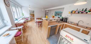 a kitchen and dining room with a table and chairs at The Dots Hostel in Zagreb