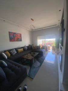 a living room with a couch and a table at Luxury apartment in Asilah Marina Golf in Asilah +5 photos