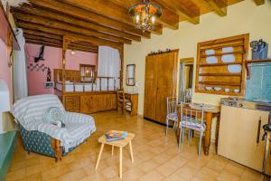 a living room with a kitchen and a dining room at Symi Garden Studios in Symi