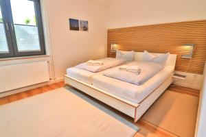 Giường trong phòng chung tại Süderdüne