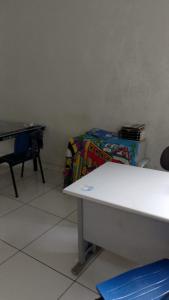 a room with a table and a bed and a desk at C&R hostel residência in Salvador +3 photos