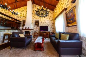 a living room with leather couches and a table at Blake's Villa in Budva