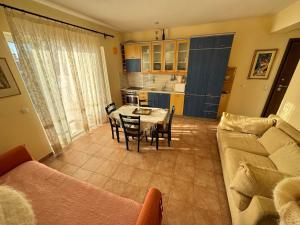 a living room with a couch and a table at Seafront Private Apartment in Neos Marmaras