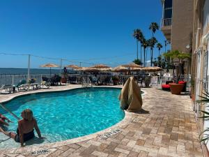 a couple of people sitting in a swimming pool at Beso Del Sol Resort in Dunedin