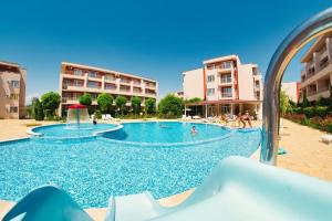 a swimming pool in a resort with people in it at The Sunny Spot in Sunny Beach