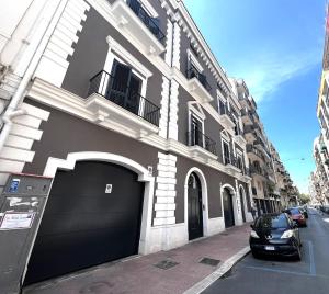 a black car parked in front of a building at Heliconia in Bari