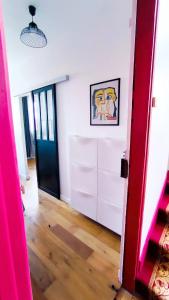 a room with white cabinets and a red door at Levalet BNB - La Défense Courbevoie in Courbevoie