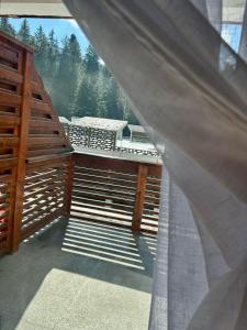 a view of a balcony with a view of the forest at Clabucet View Apartment in Predeal