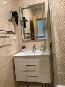 a bathroom with a sink and a mirror and a shower at Casa das Andorinhas in Lagos +35 photos