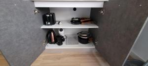 a corner of a kitchen with a shelf with coffee makers at Torremolinos CARIHUELA RENOVADO - Wifi 365 Mbps - Fire Stick Amazon - Playa a 50 metros in Torremolinos