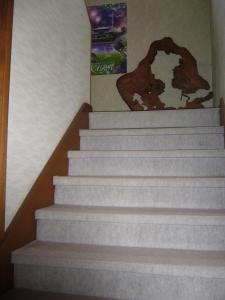 a set of stairs with a painting on the wall at Hasegawa Inn in Nara