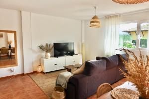 ein Wohnzimmer mit Sofa und Fernseher in der Unterkunft Casa Vacacional el Mirador de Picos in Serdió