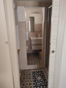 a small bathroom with a sink and a mirror at Case Vecchie in Sogliano Cavour