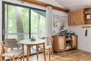 a dining room with a table and chairs and a window at Fireplace, Fire Pit & Resort Amenities in Hedgesville
