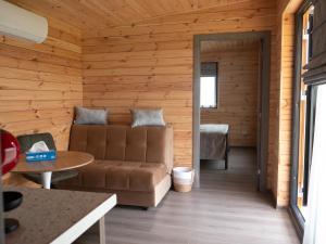 a living room with a couch and a table at Casute La Poiana in Poiana cu Cetate