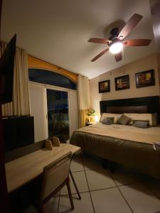a bedroom with a bed and a ceiling fan at Ocean Front- Marina View- Tiara Sands Resort, Sleeps 4 in Mazatlán