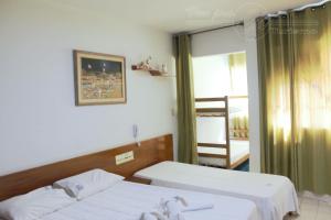 a hospital room with two beds and a window at Condomínio CTC Araras, Caldas Novas - VPC in Caldas Novas