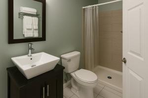 a bathroom with a toilet and a sink and a shower at Atlantic Breeze Motel & Apartments in Ocean City +18 photos