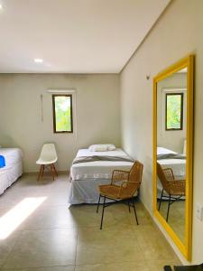 a bedroom with a bed and a mirror at Casa bem localizada em BG in Barra Grande +60 photos