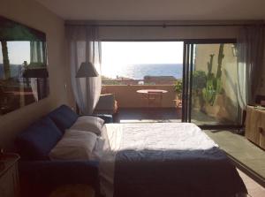 Ένα ή περισσότερα κρεβάτια σε δωμάτιο στο Cap Nioulargo