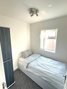 a small bedroom with a bed and a window at Single bedroom 1 in Anfield in Liverpool