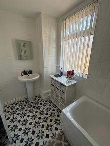 a white bathroom with a sink and a tub and a sink at Single bedroom 1 in Anfield in Liverpool