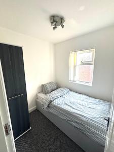 a small bedroom with a bed and a window at Single bedroom 1 in Anfield in Liverpool