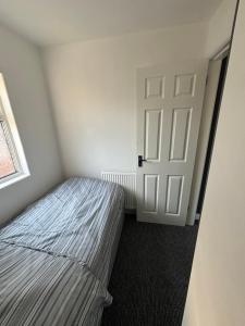 a small bedroom with a bed and a door at Single bedroom 1 in Anfield in Liverpool