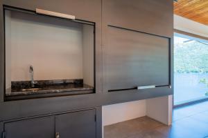 a kitchen with a sink and a large window at Suites Del Lago Peñon de Arelauquen, Bariloche in San Carlos de Bariloche