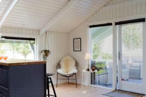 a kitchen with a counter and a chair in a room at Holiday Home With Fjord Views In Hjarbæk in Løgstrup +21 photos